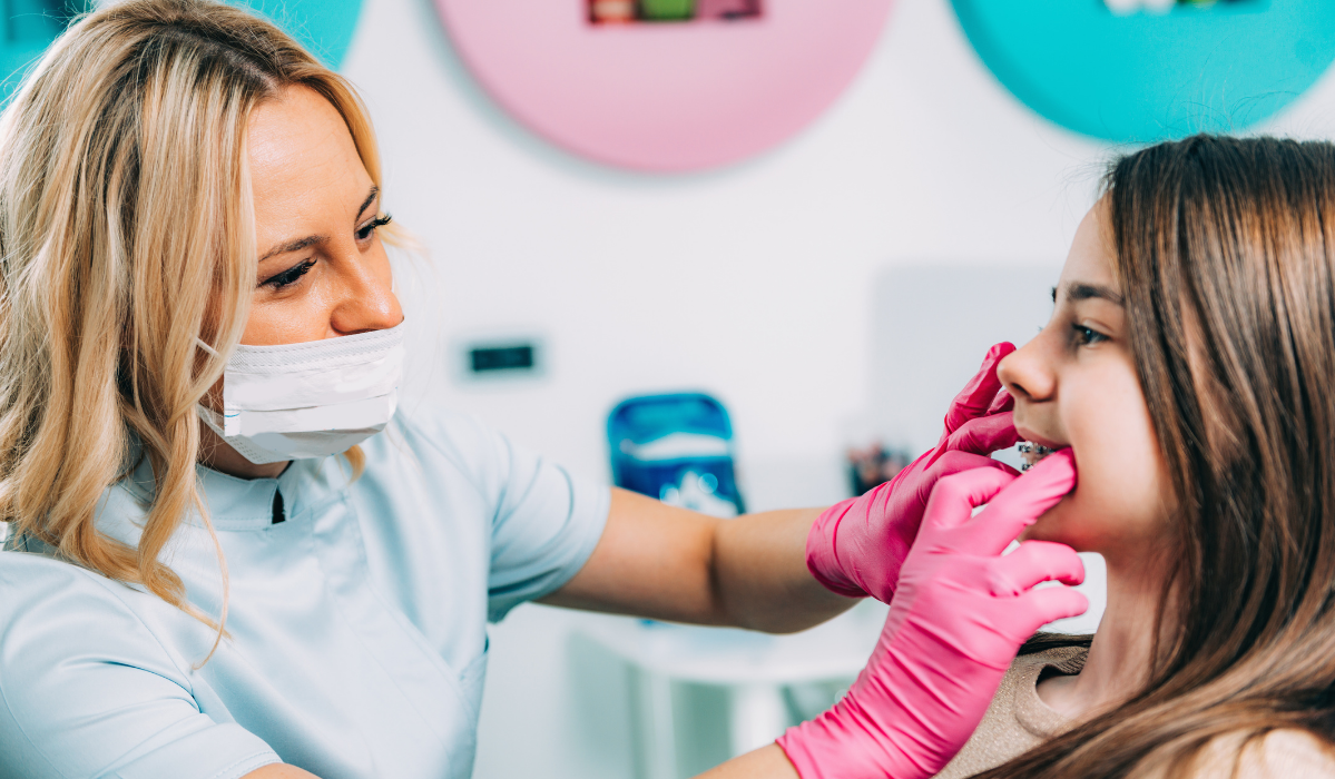Orthodontist at Pavilion Dentistry displaying recommended oral hygiene products and specialized cleaning tools for braces patients